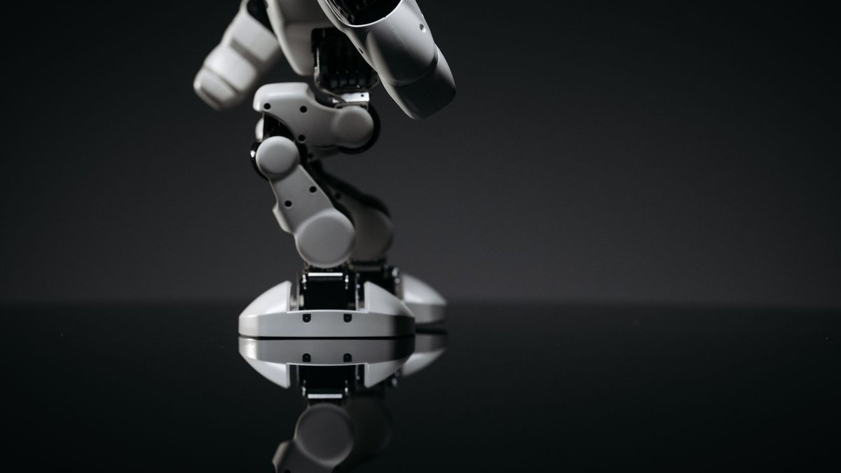 Robotic exoskeletons boost stroke recovery with precise A close-up image of a mechanical robotic arm reflecting on a dark surface, capturing industrial innovation.