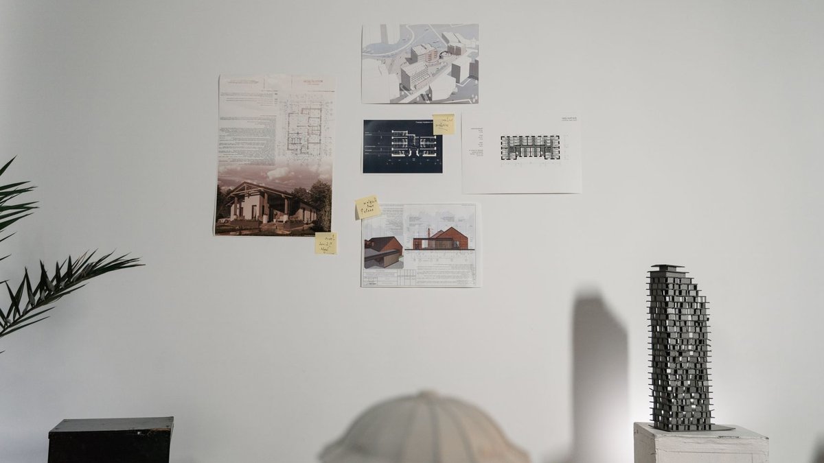 A creative architectural studio showcasing building plans and models in a modern indoor setting.