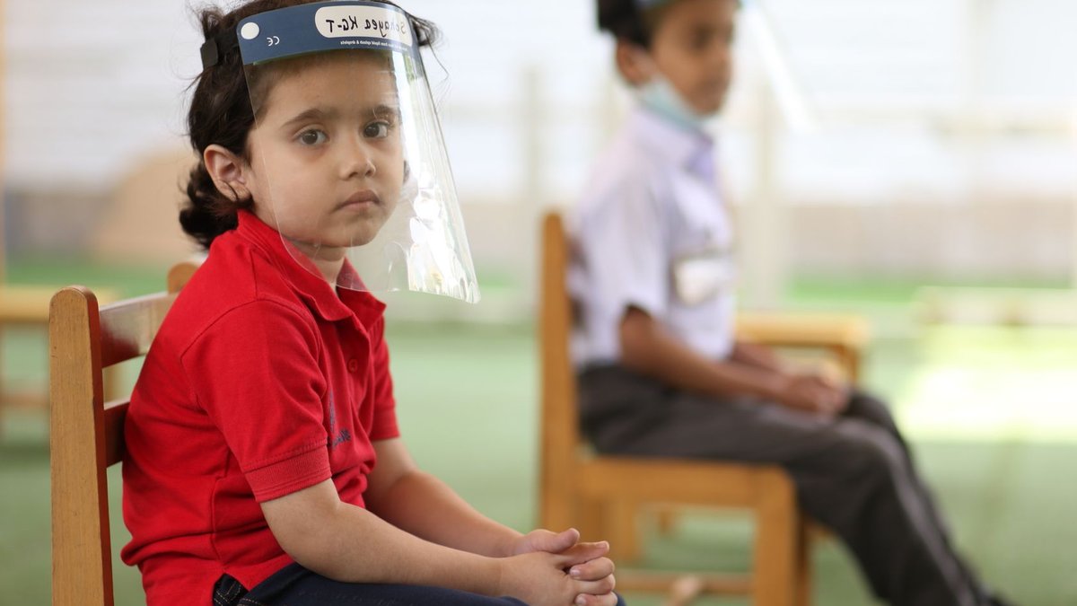 Gene signatures reveal severe COVID risk in children Children sitting in classroom wearing face shields for protection during pandemic.