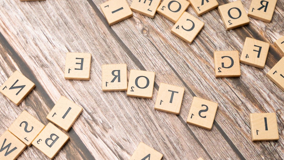 Scrabble tiles forming the word 'store' on a wooden surface, ideal for retail or typography themes.