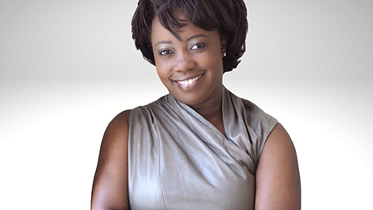 Erica Henry-Jackman portrait on grey background.