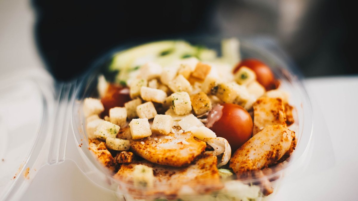 Gym Kitchen launches two high-protein meals at Tesco Delicious chicken salad with fresh greens and croutons, perfect for a healthy meal.