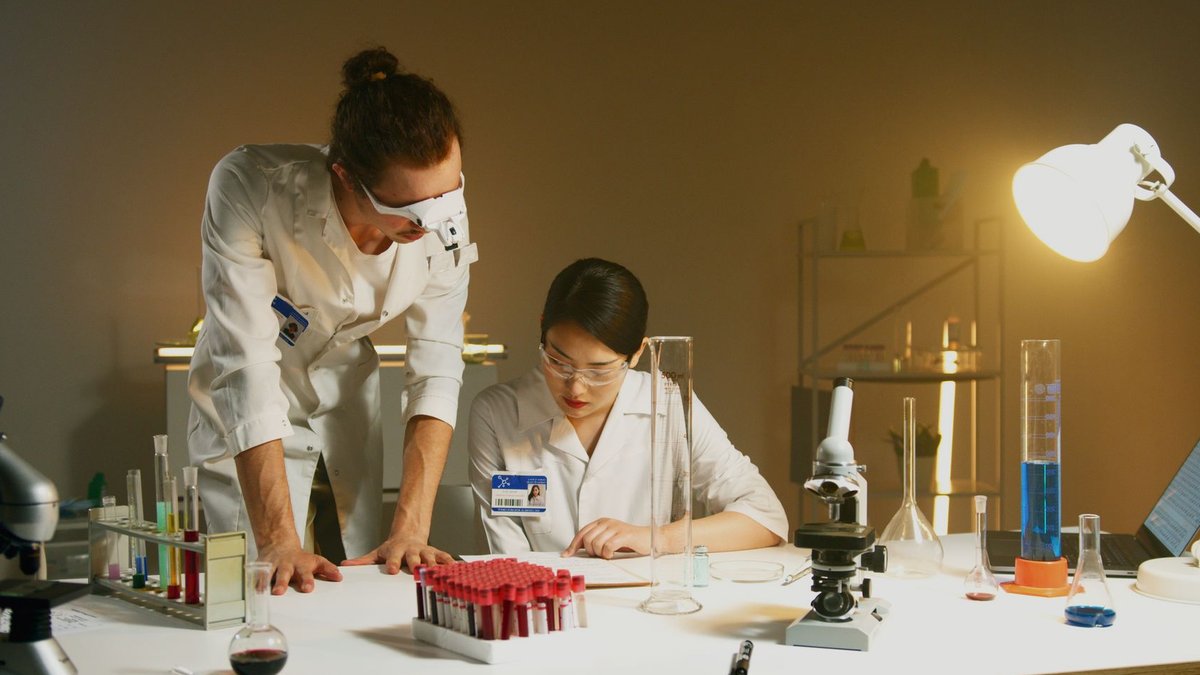 Experimental RNA Drug Reverses Scleroderma Damage in Mice Two scientists working in a laboratory conducting experiments with various equipment and samples.