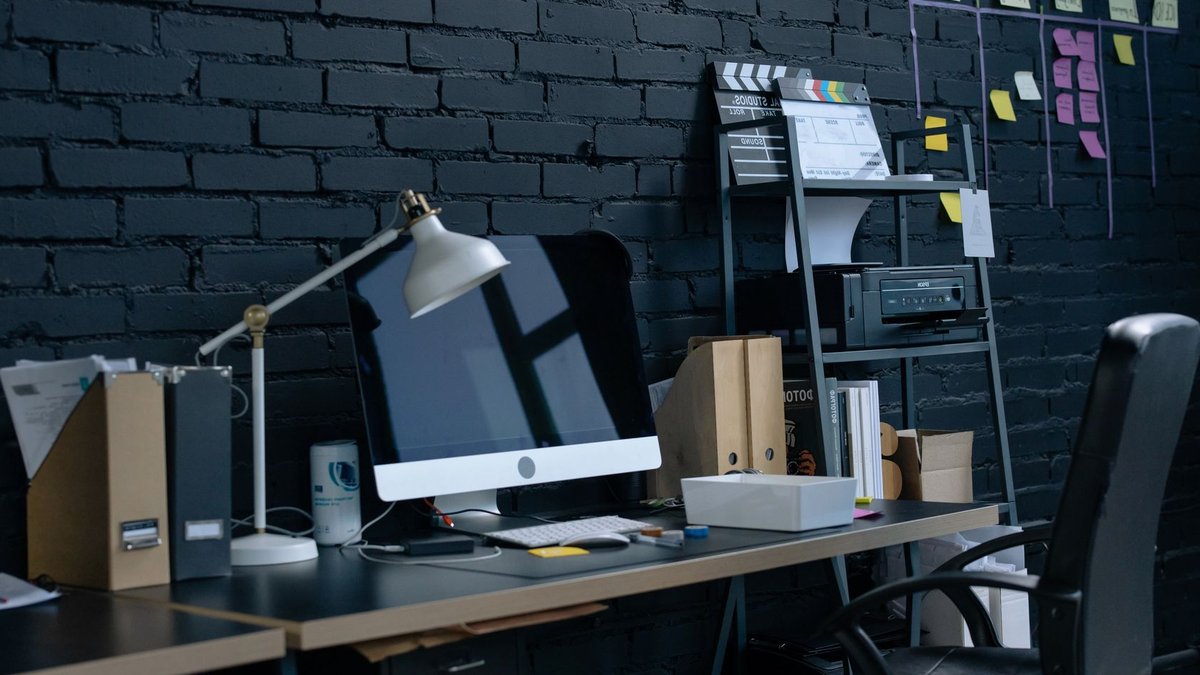 Stylish home office setup with desktop computer and organized workspace.