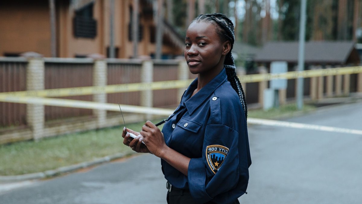 Police Probe Alleged Attack on MP Helen Haines A female police officer standing outdoors near caution tape and concrete buildings during the day.