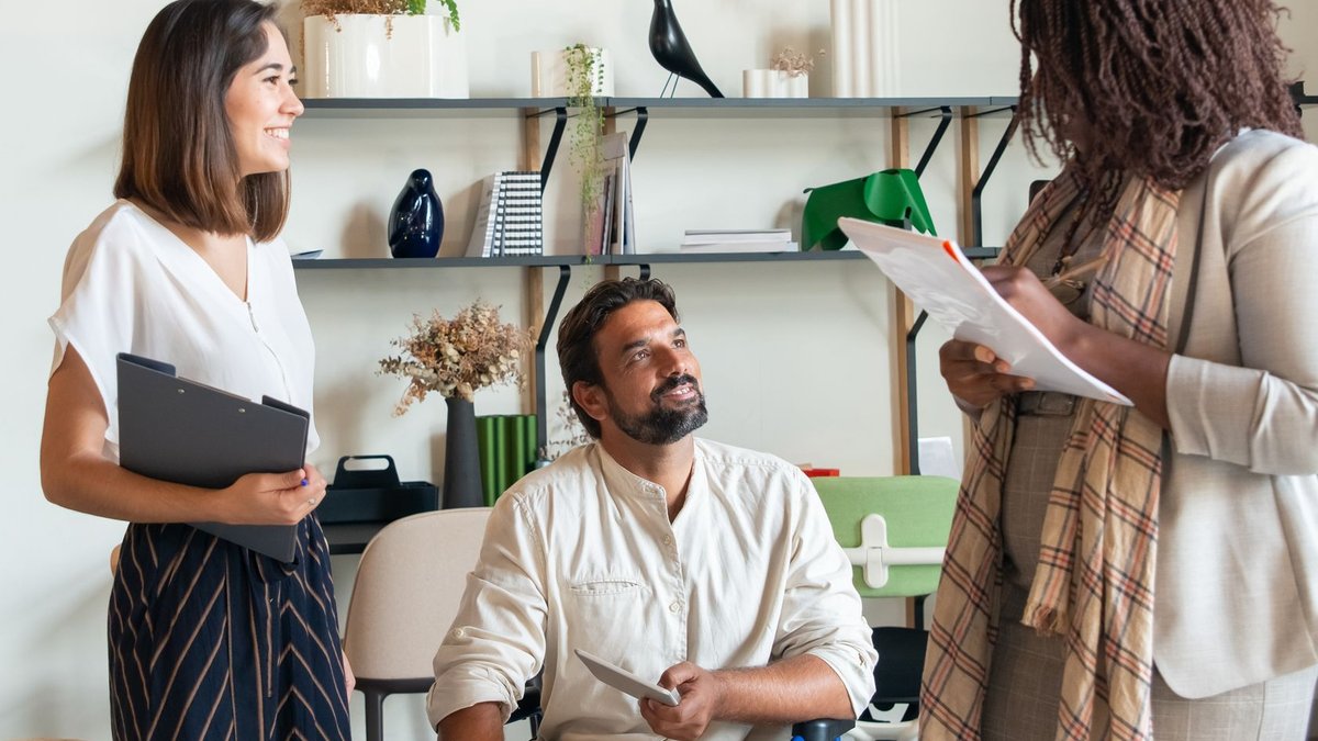 Business team discussing projects in office with diverse and inclusive environment.