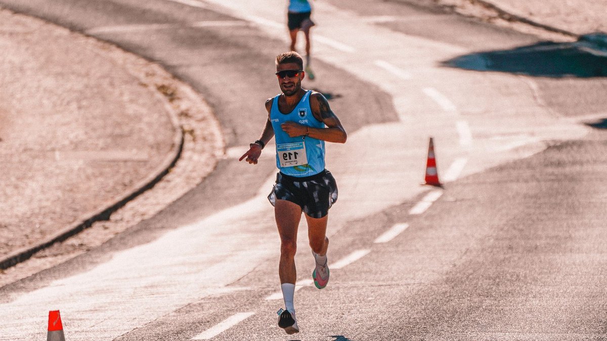 Self-coached data scientist Almgren eyes NYC Marathon upset Focused male athlete competing in an outdoor marathon race on a sunny day.