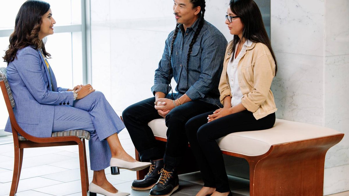 A physician speaks to a patient and his wife.