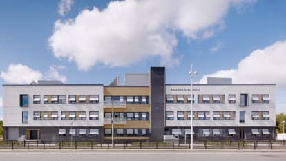 Front picture of Angered Hospital in Gothenburg. A three story flat building with orange and white facades.