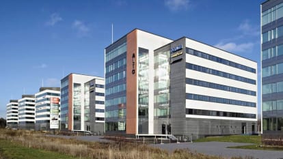 Five 5-story buildings in white and brick-red form Vantaa Business Park.