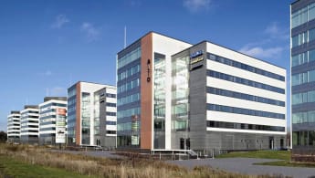 Five 5-story buildings in white and brick-red form Vantaa Business Park.