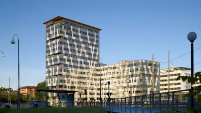 Ullevigatan office buildings, consisting of a taller structure and a lower next to it, mostly black though with white V-shaped patterns.