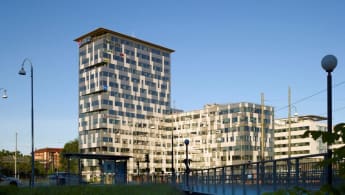 Ullevigatan office buildings, consisting of a taller structure and a lower next to it, mostly black though with white V-shaped patterns.