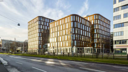 The Skånegatan office buildings in Gothenburg, with rounded edges and a brown facade.