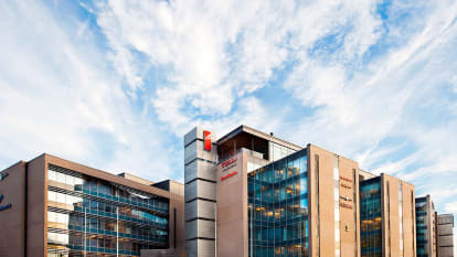 A main building extended by several wings, with a facade mostly of glass.