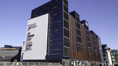 The colourful Kungsbron building, with colourful stripes from top to bottom, mixed with window openings.