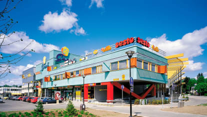 The Grani Local Centre, a colourful building with several store signs.