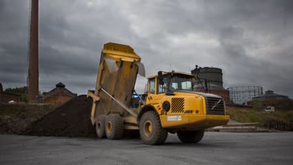 A truck dumps waste on a dedicated site.
