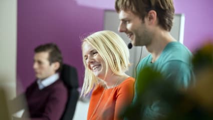 Three workers providing customer support via phone and headset.