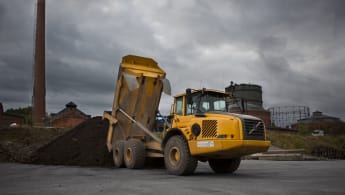 A truck dumps waste on a dedicated site.