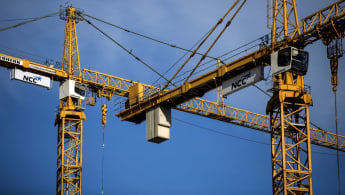 Picture of two cranes with the NCC logo on them.