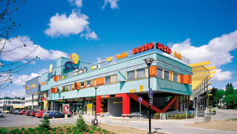 The Grani Local Centre, a colourful building with several store signs.