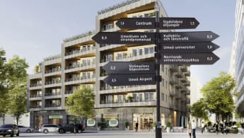 Bild på skylt med hus i bakgrunden.