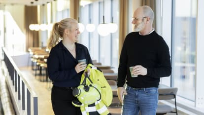 Two NCC employees talking in an office.