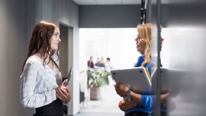 Three workers providing customer support via phone and headset.
