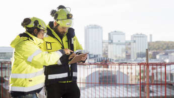 Five workers inspecting a rock wall at the Faroe Islands Eysturoy tunnel work site.