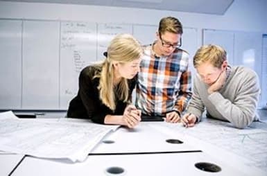 Three people talking in an office.