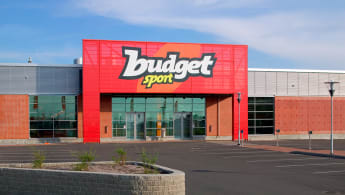 The storefront to "Budget Sport", with a mostly red facade.