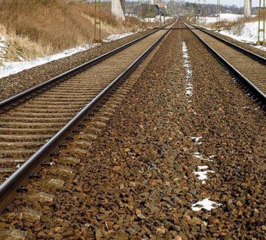 A view of slightly snow covered tracks running into the distance.