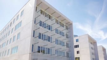 The head office of NNIT, characterised by glass panels sticking out of the facade by the help of spikes.