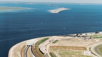 Aerial photo of the Oresund connection from Denmarks side, with the tunnel entrance, Peberholm, and the bridge all visible in the photo.