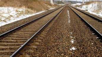 A view of slightly snow covered tracks running into the distance.