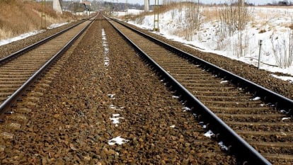 A view of slightly snow covered tracks running into the distance.