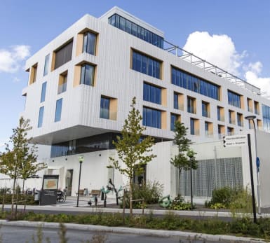 The Skandion Clinic in Uppsala, with fat, concrete, reliefed walls and windows of varying size.