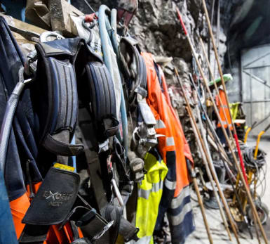 Work equipment hangs alongside a wall at the left.