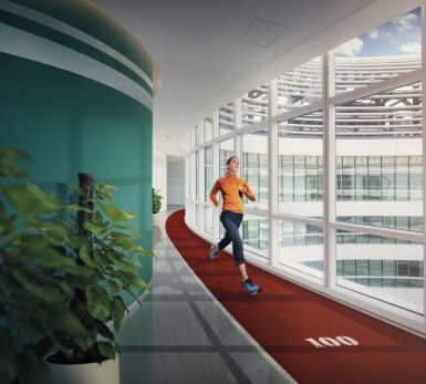 Illlustrative picture of a woman running on an indoor running track.