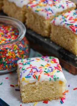 Moist VanillaCake Square topped with Frosting and Sprinkles 