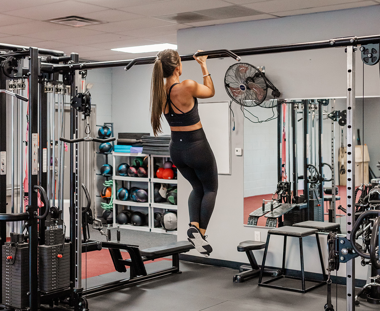 Abby performs a pull-up.