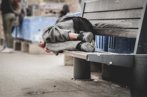 person sleeping on bench