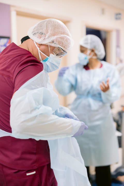 Hospital staff donning PPE