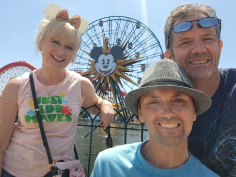 Family in front of ferris wheel