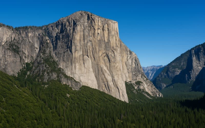 A breathtaking aerial view of El Capitan in Yosemite National Park under a clear blue sky.