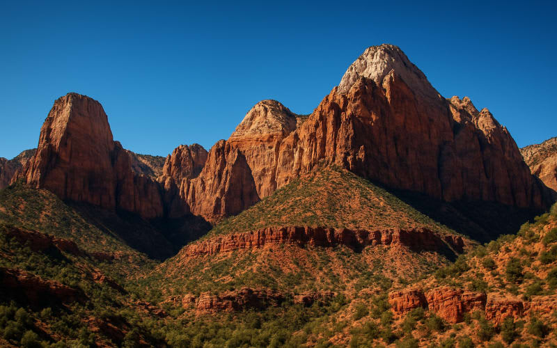 A breathtaking view of Zion National Park's red cliffs and towering rock formations under a clear blue sky.