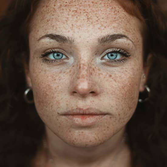 Close-up of a woman with glowing, youthful skin and a natural smile, showcasing the results of advanced skin rejuvenation treatments using biosomes and exosomes. Perfect complexion, long lashes, and smooth texture highlight the anti-aging effects of regenerative skincare technology.