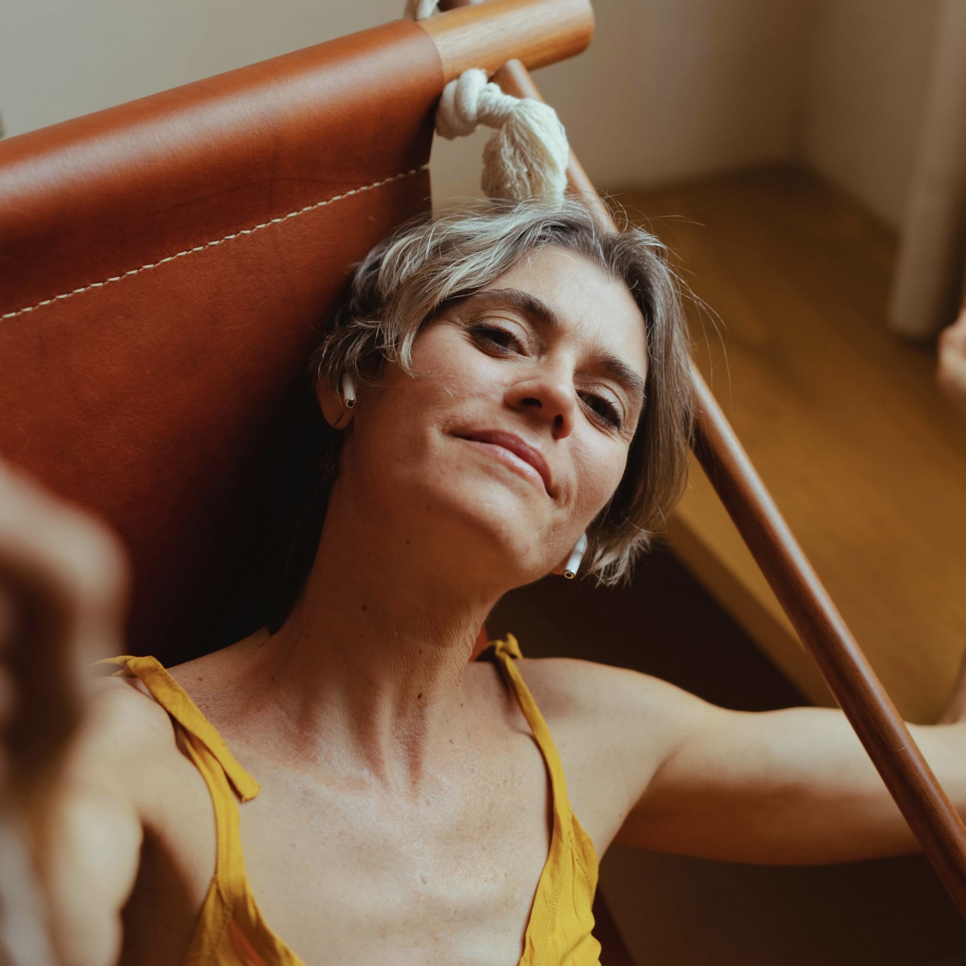 beautiful, mature woman with a knowing smile, symbolizing vitality and wellness with Hormone Replacement Therapy (HRT); ideal representation of menopause relief and anti-aging benefits for women through hormone balance.
