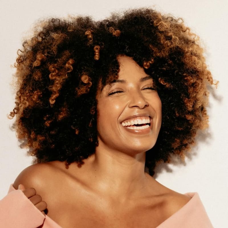 Smiling woman with flawless, clean skin showcasing the impact of consistent medspa treatments and professional skincare strategies.